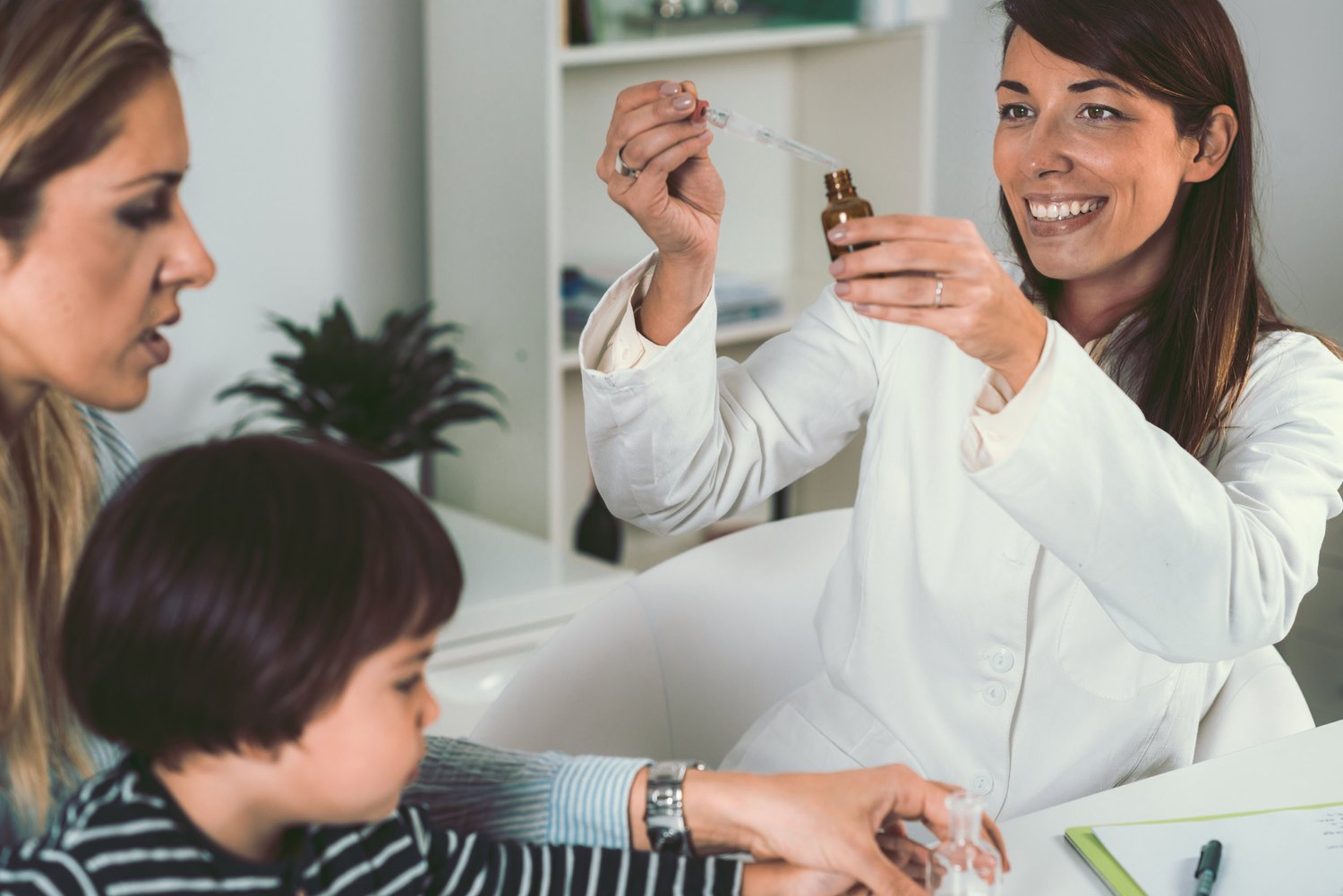 homeopathy mother and little boy visiting homeopathic practitioner for homeopathic treatments