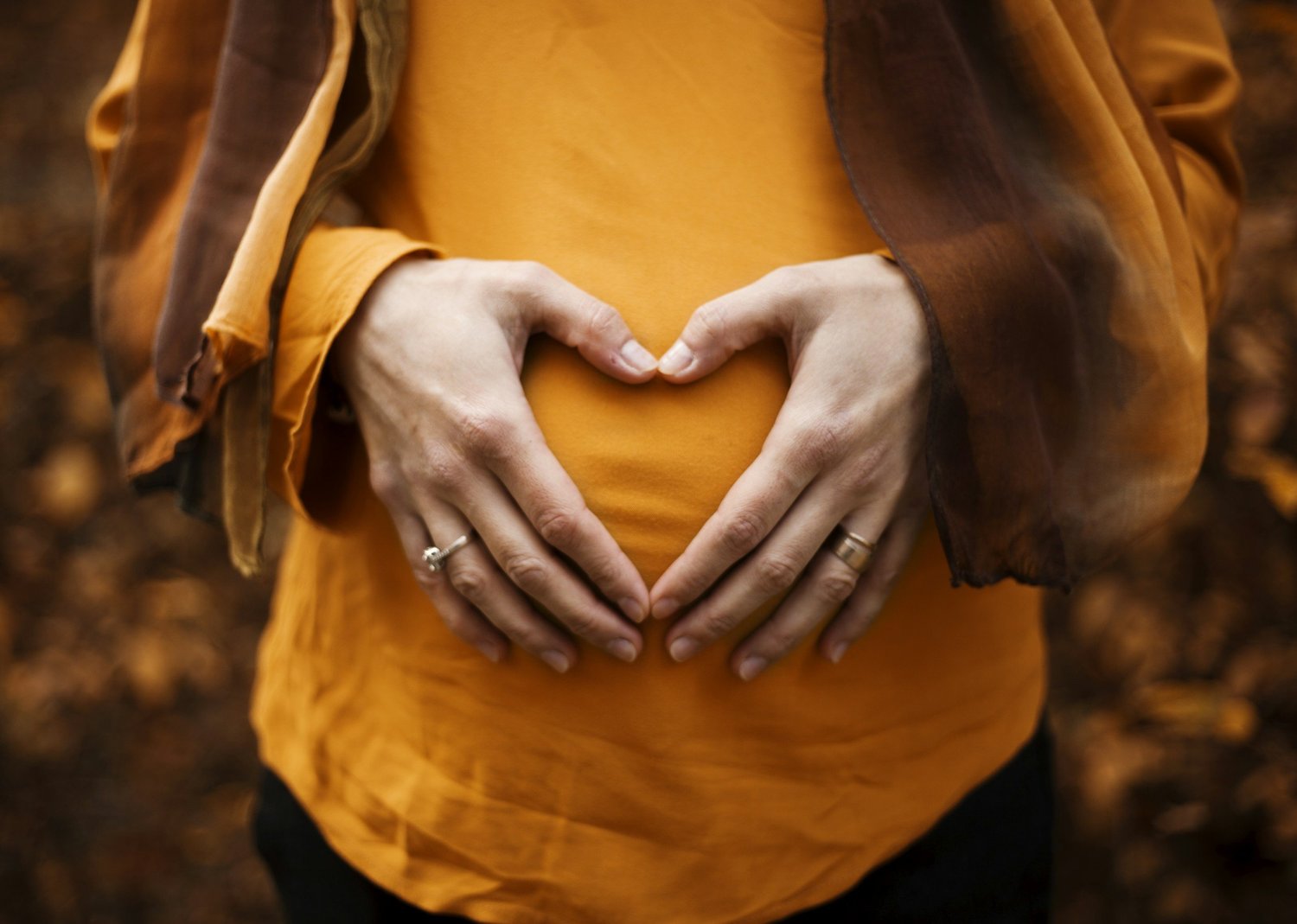 girl holding her stomach - pregnant women happy