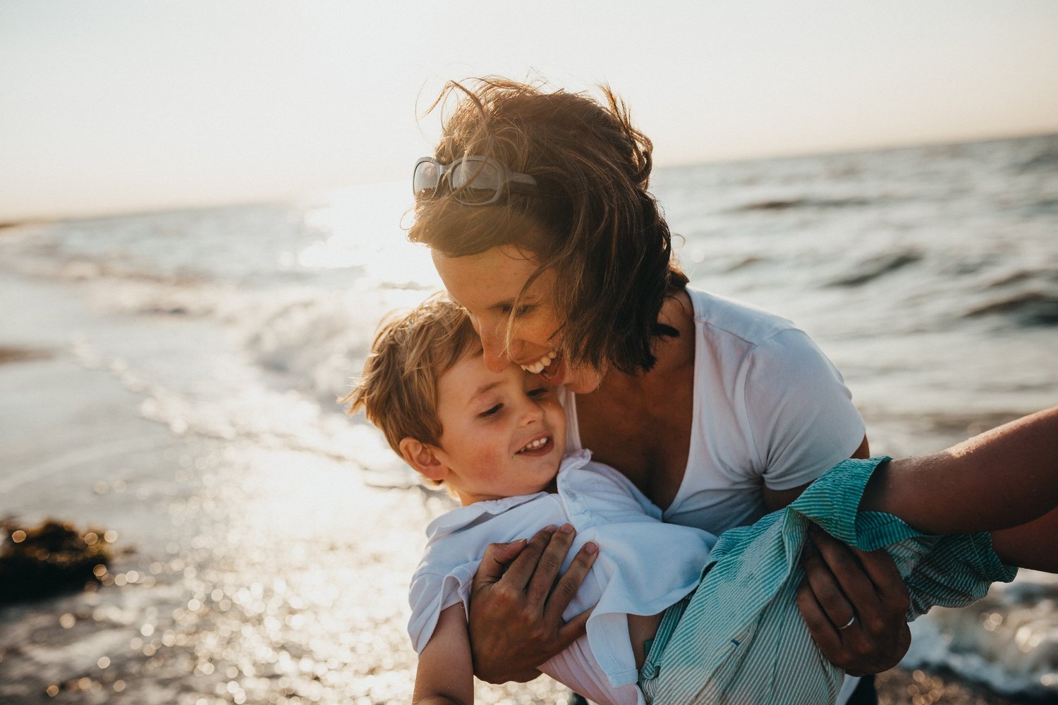 mom and kid having fun on the beach feeling their best selves and no more adrenal fatigue